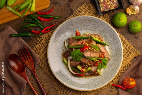 Obraz Spicy Grilled beef with Cucumber Salad,grilled meat with onion and sliced cucumber in chilli lime sauce.(Yum Neua Yang).Top view