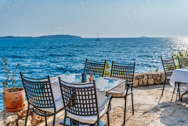 Fototapeta table and chairs on the beach of Adriatic Sea