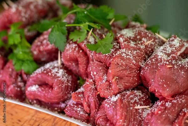 Fototapeta Horse meat Braciole or Brasciole, are a typical dish from the province of Bari in Puglia. Braciole are bundles of meat, stuffed with a mixture of parsley, garlic, and cheese in a butcher's for sale