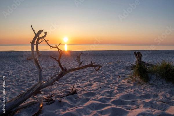 Obraz Sunset over the Baltic Sea illuminating the serene Darß Peninsula beach in Germany