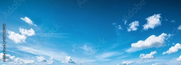 Fototapeta Wide shot of clear blue sky with few clouds for creative projects