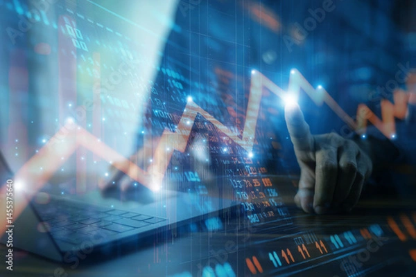 Fototapeta Businessman analyzing investment charts and financial data during periods of high market volatility to make informed decisions