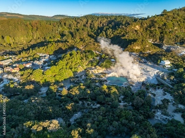 Fototapeta Aerial view of Wai-O-Tapu geothermal area, near Rotorua, New Zealand. Steam rises from the hot springs, a popular tourist destination. The area is known for its colorful pools.