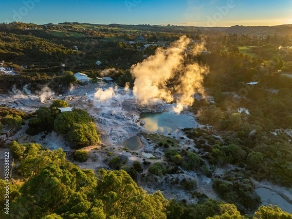 Fototapeta Aerial view of the Wai-O-Tapu geothermal area in Rotorua, New Zealand. Steam rises from the hot springs, a popular tourist destination due to its unique volcanic landscape.