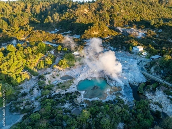 Fototapeta Aerial view of the Te Puia geothermal park in Rotorua, New Zealand. Tourists walk along the boardwalk to view the geysers and hot springs. The park is a popular tourist destination.