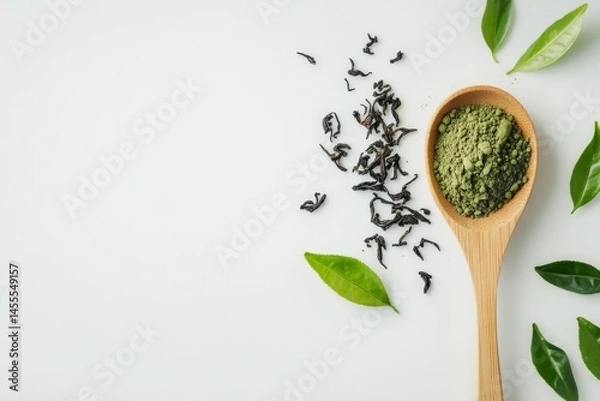 Fototapeta Photo of green tea powder on a wooden spoon and tea leaves placed next to it on white background , Generative AI