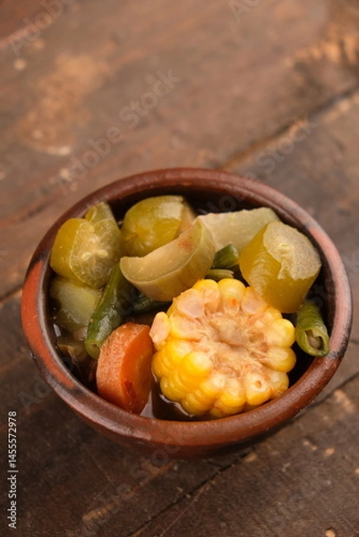 Fototapeta Sayur asem. Sayur asam is a type of sour vegetable dish typical of Indonesia. served on an earthenware bowl