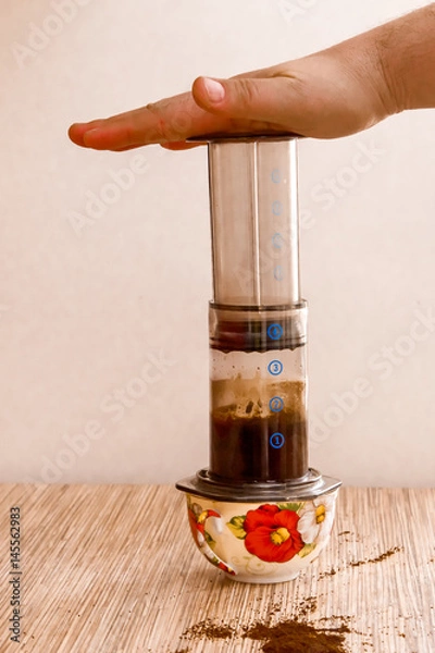 Obraz Preparation of ground coffee in aeropress - portable filter coffee maker
