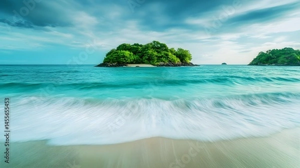 Obraz A lush green island surrounded by turquoise ocean water and white sand
