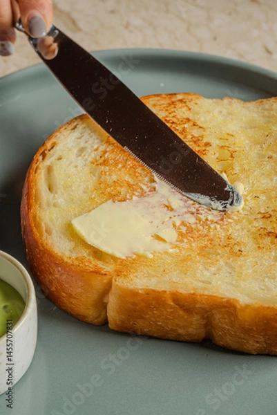 Fototapeta Buttered Toast A GoldenBrown Slice Warm and Delicious