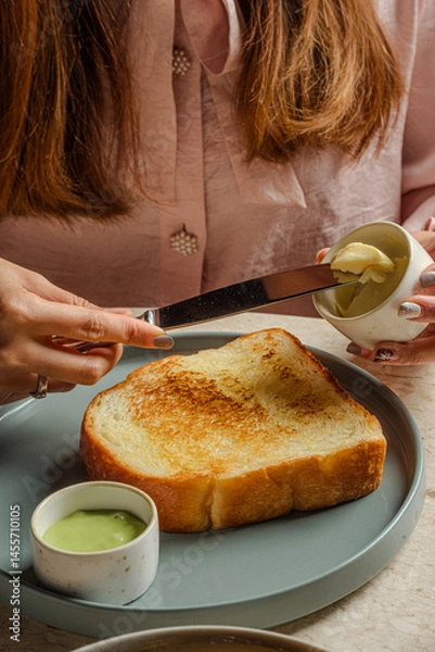 Fototapeta Golden Toasted Bread with Butter and Spread A Serene Culinary Moment