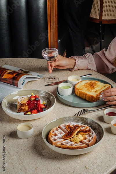 Fototapeta Elegant Brunch Waffles French Toast and Berries in a Serene Setting