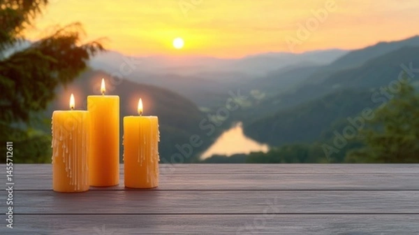 Fototapeta Two glowing candles on a table with a scenic view of a lake creating a cozy atmosphere for relaxation and tranquility