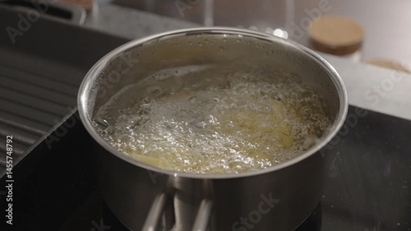 Obraz fettuccine boiling in saucepan with back light