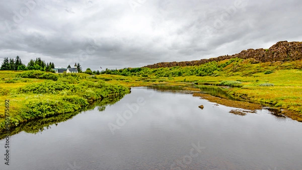 Fototapeta Thingvellir National Park, Iceland, Famous geological and historical site with a river stream and a church, summer, South West Iceland, scenic dramatic view
