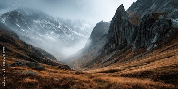 Obraz Misty Cliffside Mountain Rising Above Golden Grass Hillside in Autumn Light, Dramatic Landscape with Steep Rocky Slopes, Rugged Nature Scene Evoking Solitude, Wilderness, and Majestic Elevation
