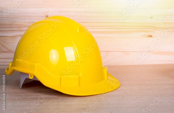 Fototapeta Close up safety helmet on wooden background