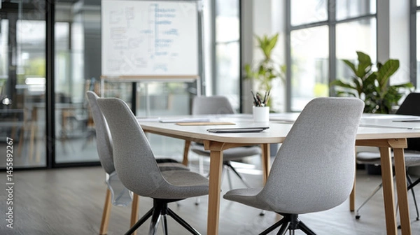 Fototapeta Modern meeting room with stylish chairs and plants, creating productive atmosphere