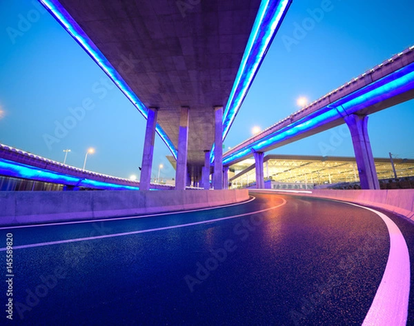 Obraz Empty road floor with city viaduct bridge of neon lights night