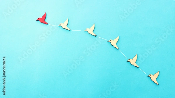 Fototapeta Concept image of birds following the leader. Idea of teamwork and moving ahead