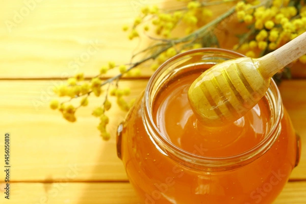 Fototapeta Honey dripping and glass jar full of honey                               