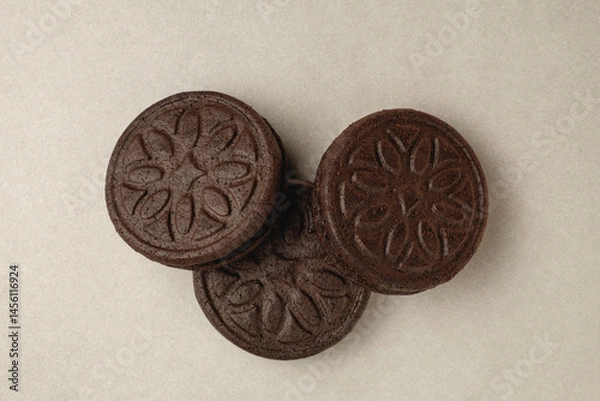 Fototapeta Delicious chocolate cookies arranged in an artistic display on a beige surface