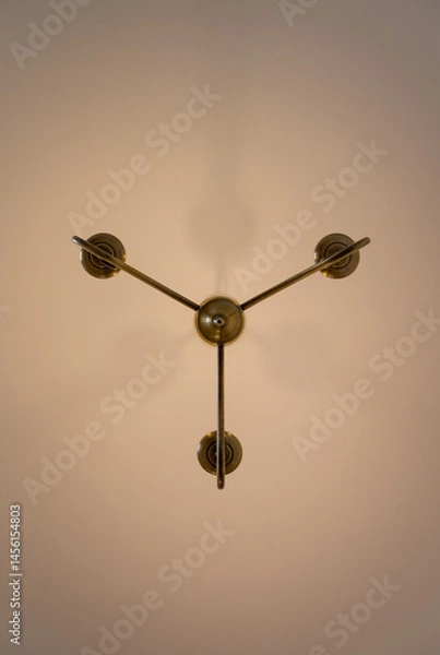 Fototapeta Chandelier style electric light fitting on a ceiling seen directly from below. Portrait view.