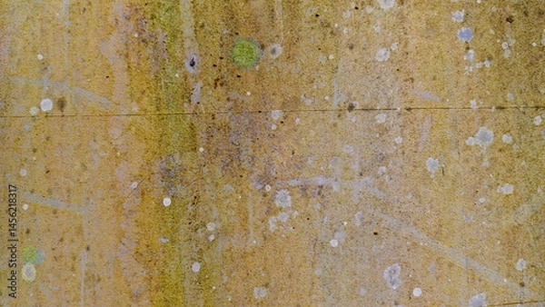 Fototapeta Close-up of an abstract surface with a rough, textured appearance. The image features a blend of colors, including brown, yellow, green, and blue, creating a unique and visually interesting pattern. 