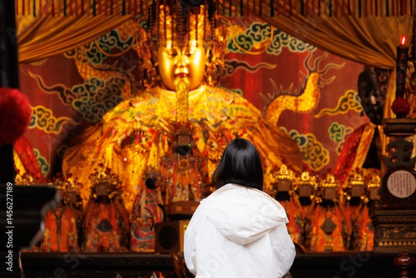 Fototapeta Asian Chinese people praying, Make a wish in front of Mazu or Matsu golden statue in Taiwan Temple