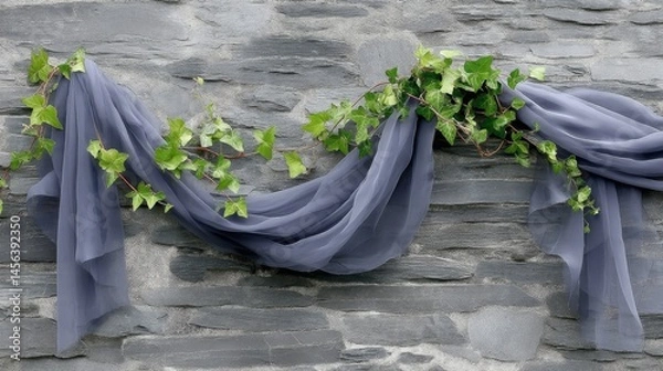Obraz Sheer fabric flows gracefully intertwined with ivy, draping against a rugged stone wall, highlighting an atmosphere of timeless elegance and natural beauty