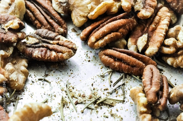 Fototapeta Healthy mixed nuts - walnut and pecan with rosemary