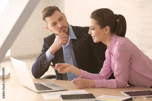 Obraz Young managers discussing issues in office