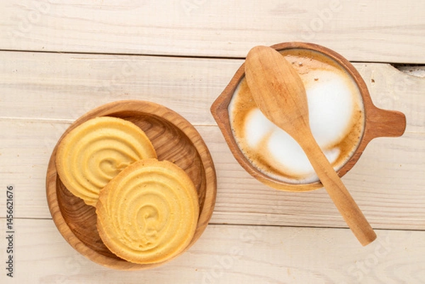 Fototapeta Shortbread sweet cookies with kitchen utensils on a wooden table, close-up, top view.