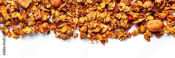 Fototapeta Granola panorama on a white background, with copy space. Organic gourmet muesli, overhead flat lay shot
