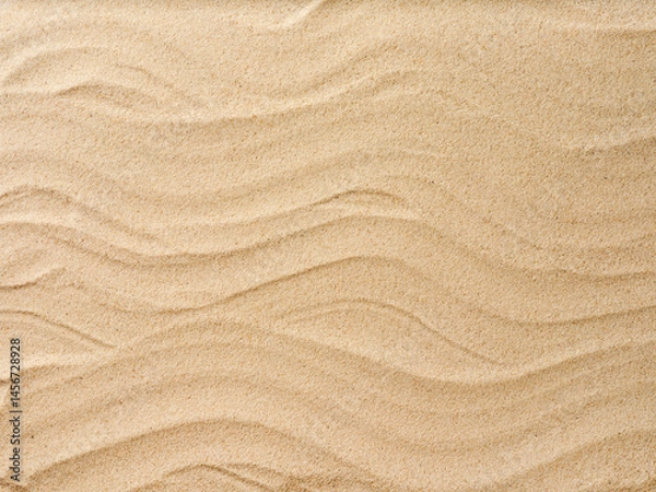 Obraz Beach sand background with natural wave pattern. Summer background of beach sand with small stones along the edges. Tourism, vacation and holidays concept. Top view.