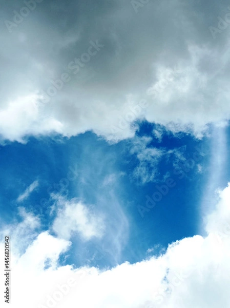 Fototapeta Serene blue sky adorned with soft, fluffy white clouds