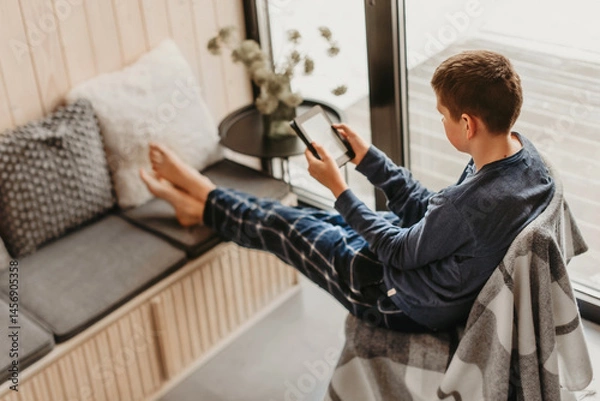 Fototapeta Teenager Kid Reading Book in Log Cabin