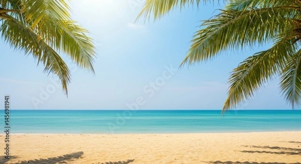 Fototapeta Tropical beach scene with palm trees framing the clear blue sky and calm turquoise ocean view