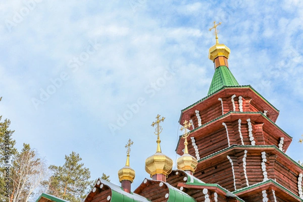 Obraz A group of gold and silver crosses are on top of a building