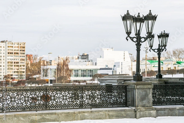 Obraz A city street with a row of street lamps on a snowy day in Yekaterenburg Russia