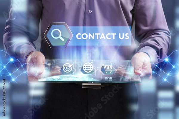 Obraz Business, Technology, Internet and network concept. Young businessman working on a virtual screen of the future and sees the inscription: Contact us