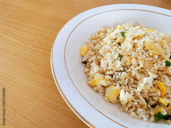 Obraz Nasi Goreng or fried rice with scramble eggs simple Indonesian food. Copy-space.