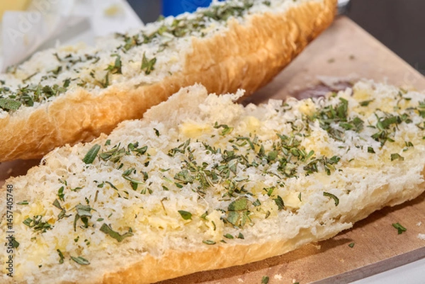 Fototapeta Preparing and Baking Garlic Bread with Herbs in Kitchen
