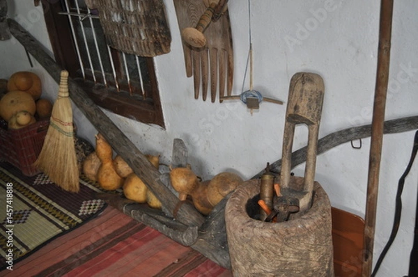 Fototapeta Rustic Interior with Traditional Tools and Gourds Displayed on Wall