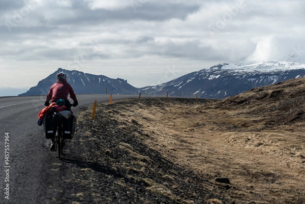 Fototapeta View of mountains on the Snæfellsnes peninsula in Iceland with woman on a bike in the foreground.