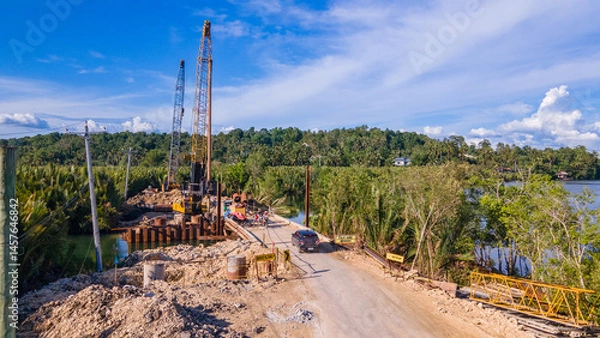 Fototapeta construction and reconstruction of a river bridge on a tropical island in the Philippines, drone view