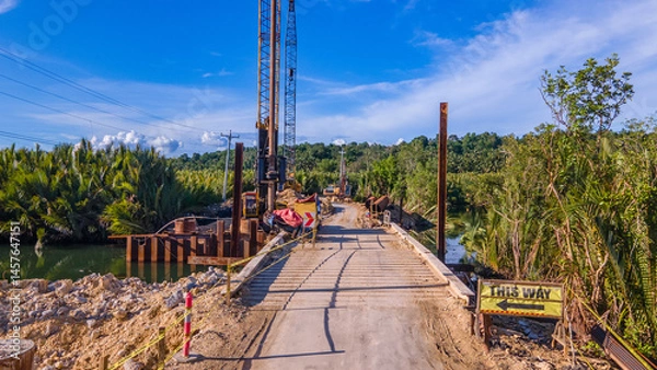 Fototapeta construction and reconstruction of a river bridge on a tropical island in the Philippines, drone view