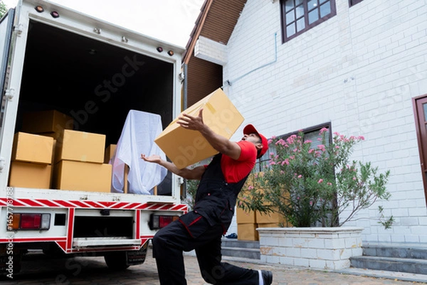Fototapeta Man in accident slipped and fall the floor in front of the house, Indian worker improvident fell to hold heavy box overloading, life insurance, welfare benefits, compensation for employees in company