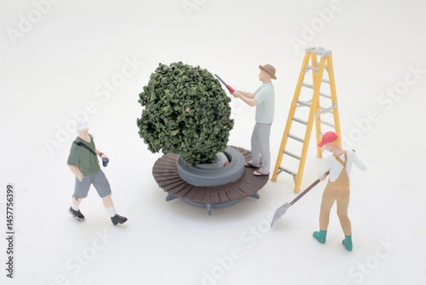 Fototapeta Miniature Figures Working Together on a Garden Project Scene