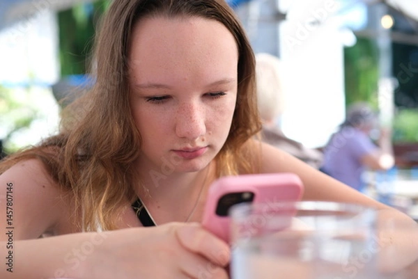 Obraz Shocked concerned cellphone user girl staring at screen, looking at smartphone screen, finding problems with online app, poor connection, Internet service, getting surprising bad news. 